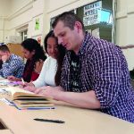 Four people working at a desk